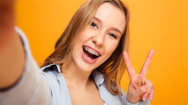 girl smiling with peace sign